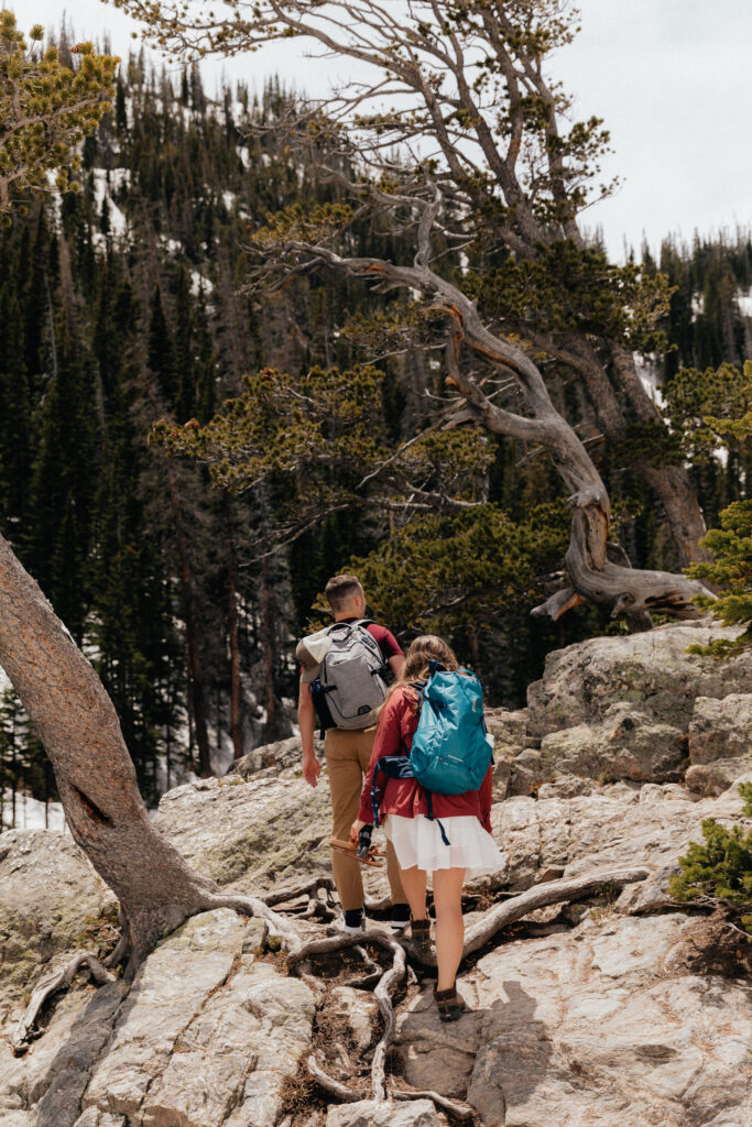 Hiking engagement photos in Rocky Mountain National Park at Dream Lake