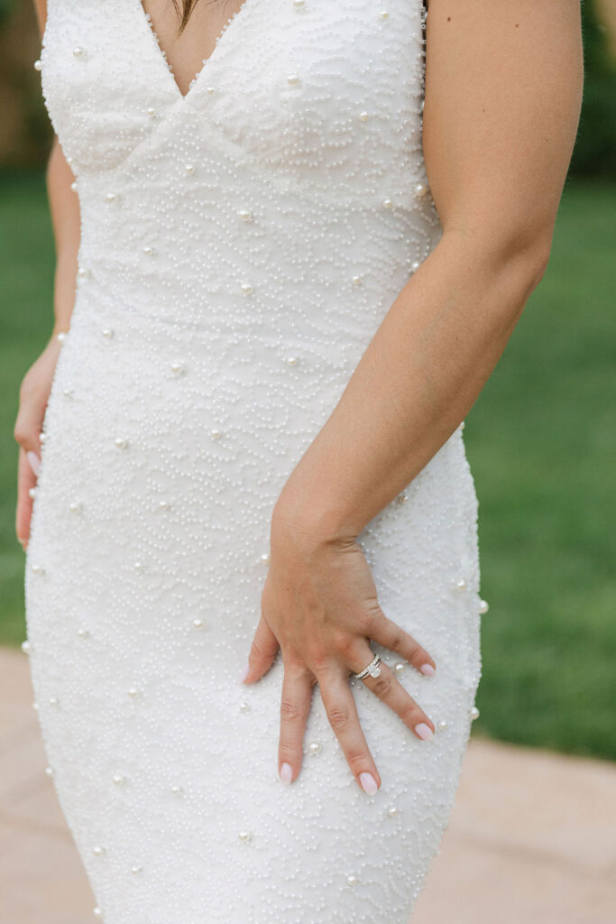 Close-up of bride’s beaded gown at European-inspired Colorado wedding venue.