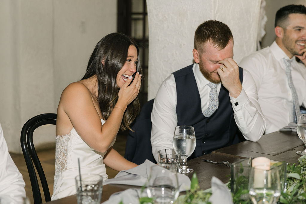 Bride and groom laughing during dinner speeches at Villa Parker.