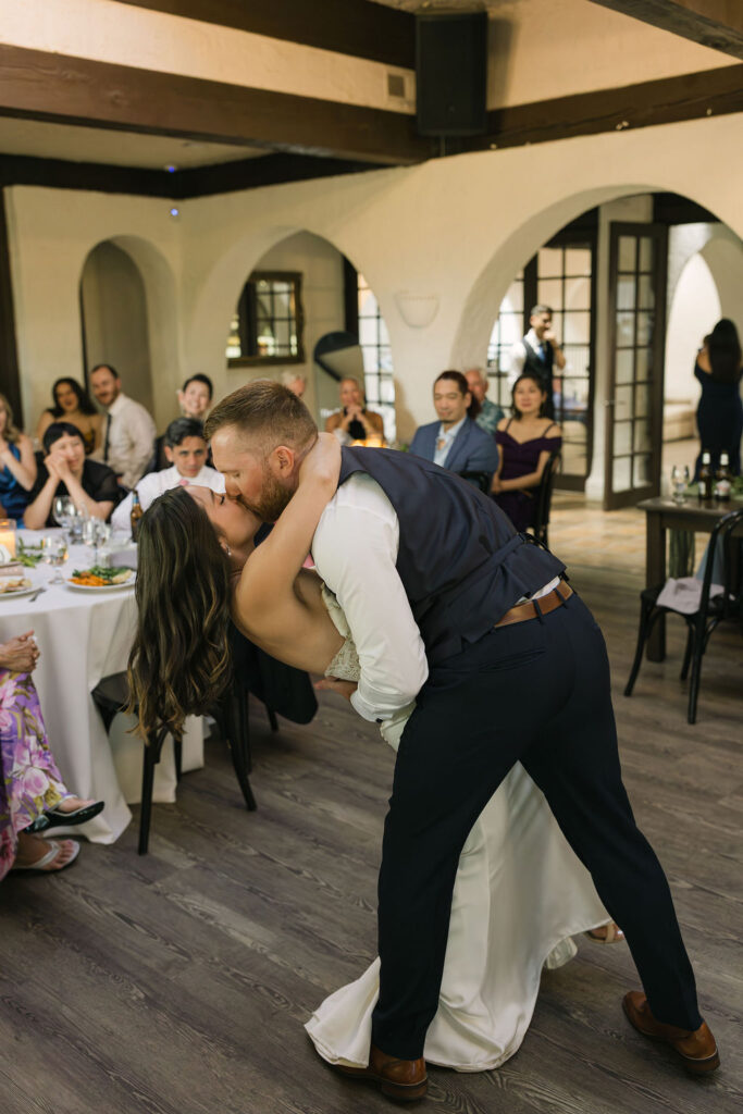 Groom dipping bride during first dance inside Villa Parker venue.