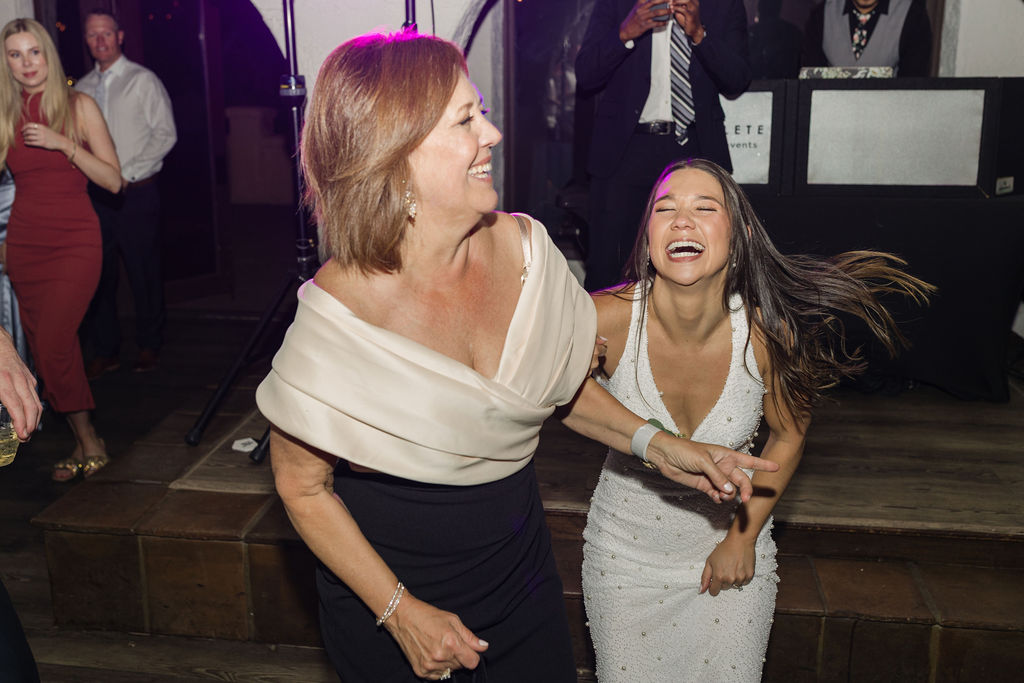 Parent dancing with bride during lively Colorado wedding reception.