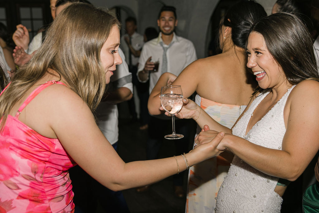 Bride dancing with friend during Colorado wedding reception.