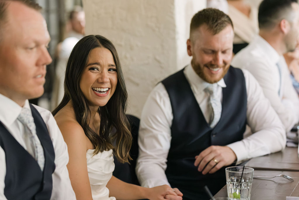 Bride laughing with wedding party during Villa Parker reception.