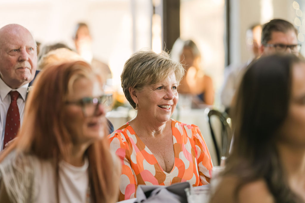 Candid photo of guest smiling during wedding toasts at Villa Parker.
