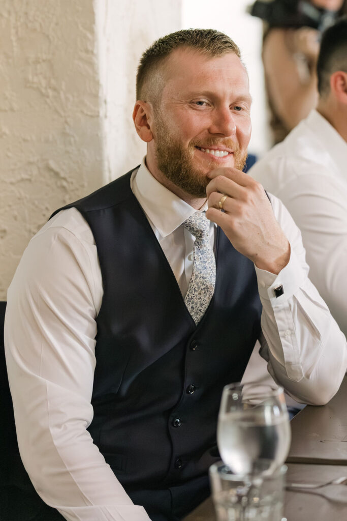 Candid photo of guest smiling during dinner at Colorado wedding reception.