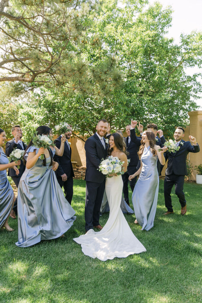 Bride and groom celebrating with their full wedding party in the garden at Villa Parker, a European-inspired Colorado wedding venue.