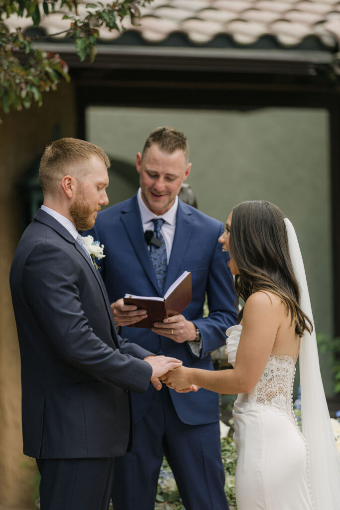 Bride and groom exchanging vows during their Villa Parker ceremony at this European-inspired Colorado wedding venue.