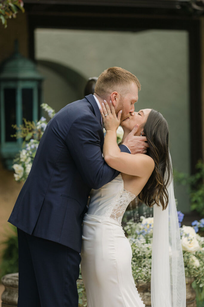 Bride and groom sharing their first kiss at the Villa Parker ceremony during their Colorado wedding.