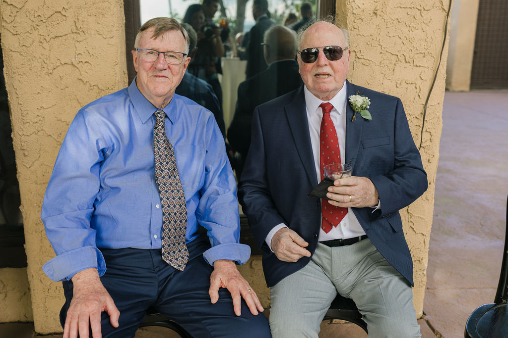 Two older guests smiling while seated at Villa Parker wedding.