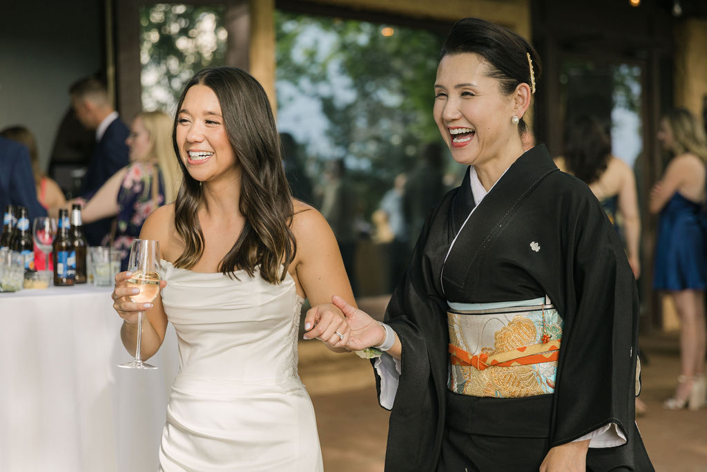 Bride laughing with family member in kimono at Colorado wedding.