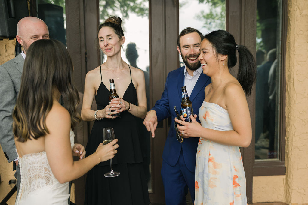 Bride chatting with guests during cocktail hour at Villa Parker.
