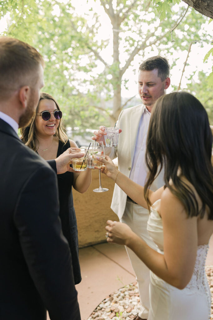 Bride and groom toasting with guests during Villa Parker cocktail hour.