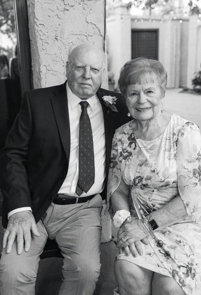 Older couple smiling during cocktail hour at Villa Parker wedding.
