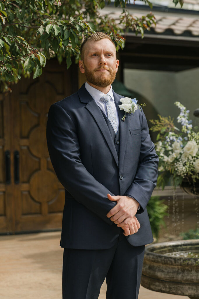 Groom standing at the ceremony altar at Villa Parker, waiting for the bride during their Colorado wedding.