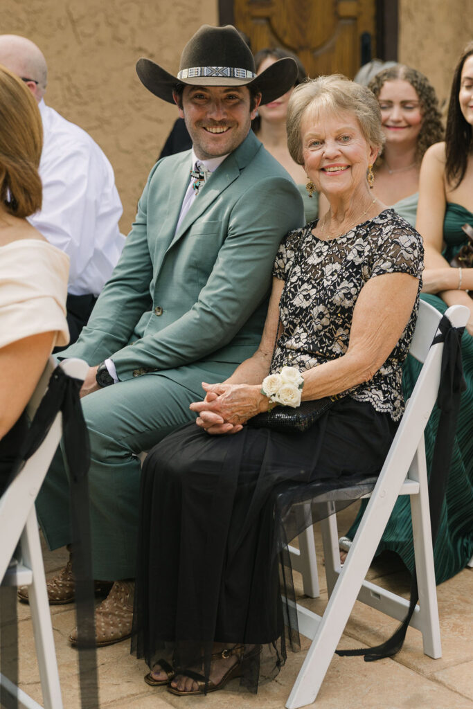 Guests seated for the ceremony at Villa Parker, including one guest wearing a cowboy hat, during a Colorado wedding celebration.