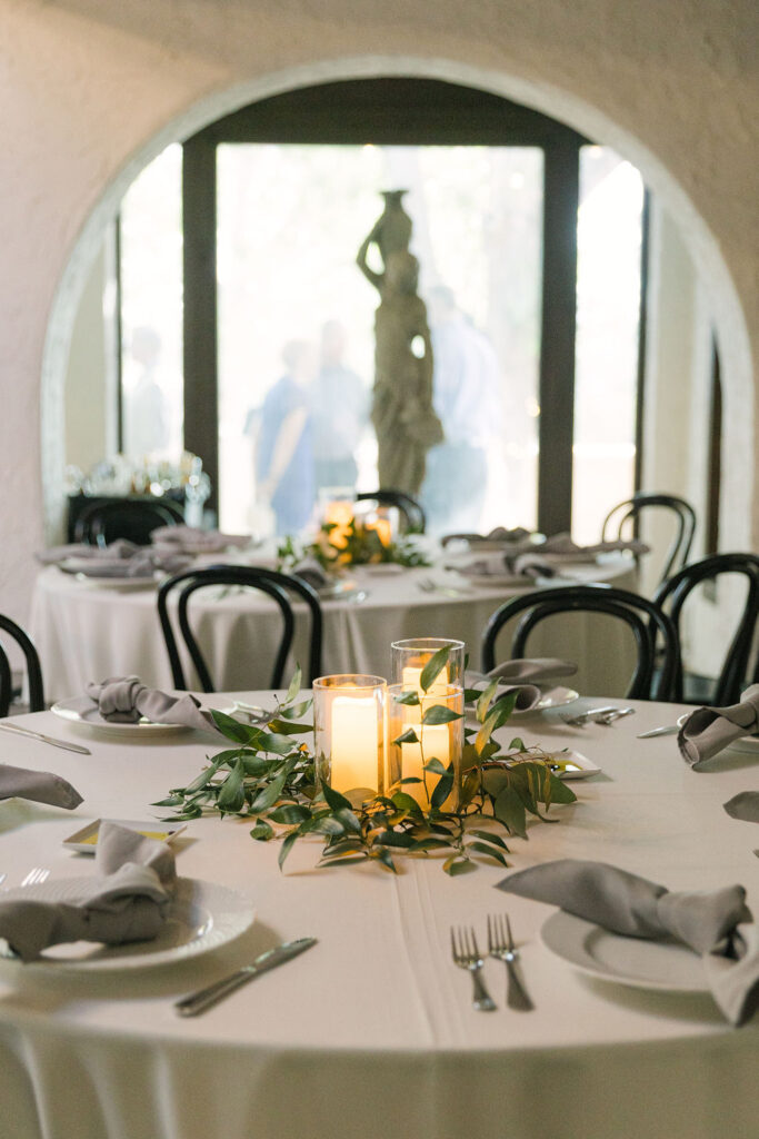 Elegant table settings with candles and greenery at Villa Parker wedding reception.