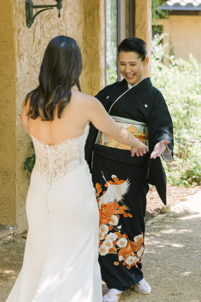 Bride sharing joyful moment with family member during Villa Parker wedding day.