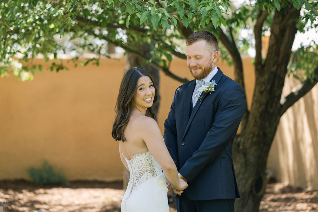 Bride smiling over shoulder during portraits at European-inspired Villa Parker.