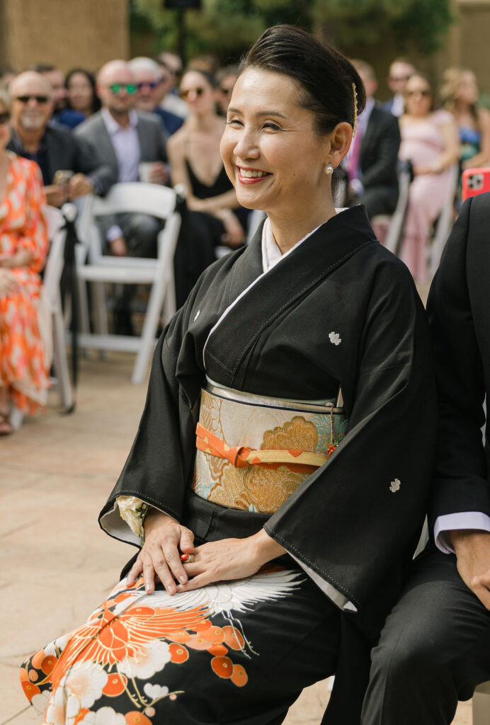 Wedding guest dressed in formal kimono seated at the Villa Parker ceremony in Colorado.