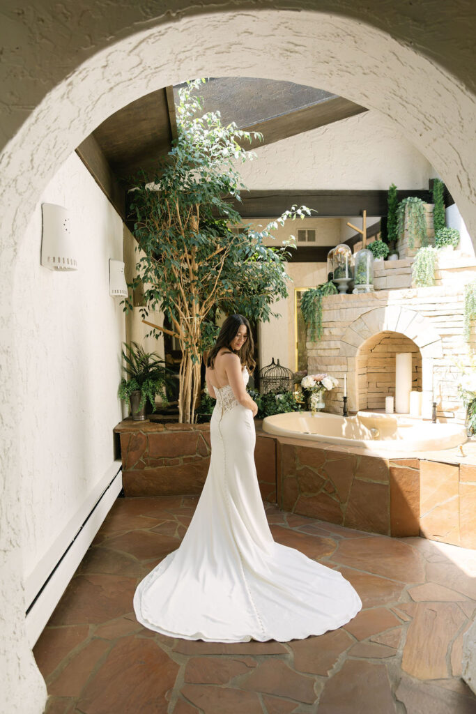 Bride standing in elegant indoor space at Villa Parker in her wedding gown.