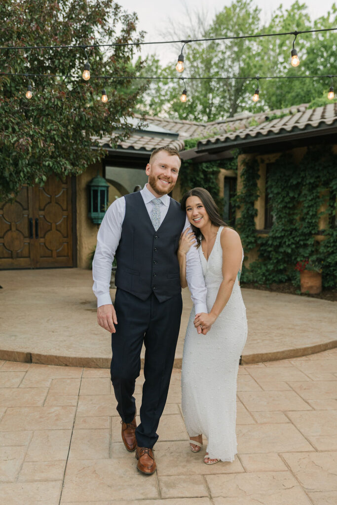 Bride and groom walking in the courtyard of Villa Parker, a Colorado wedding venue.