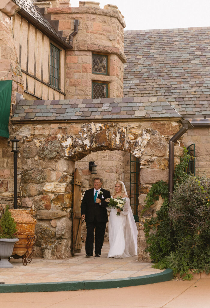 bride walking down aisle at cherokee ranch and castle wedding