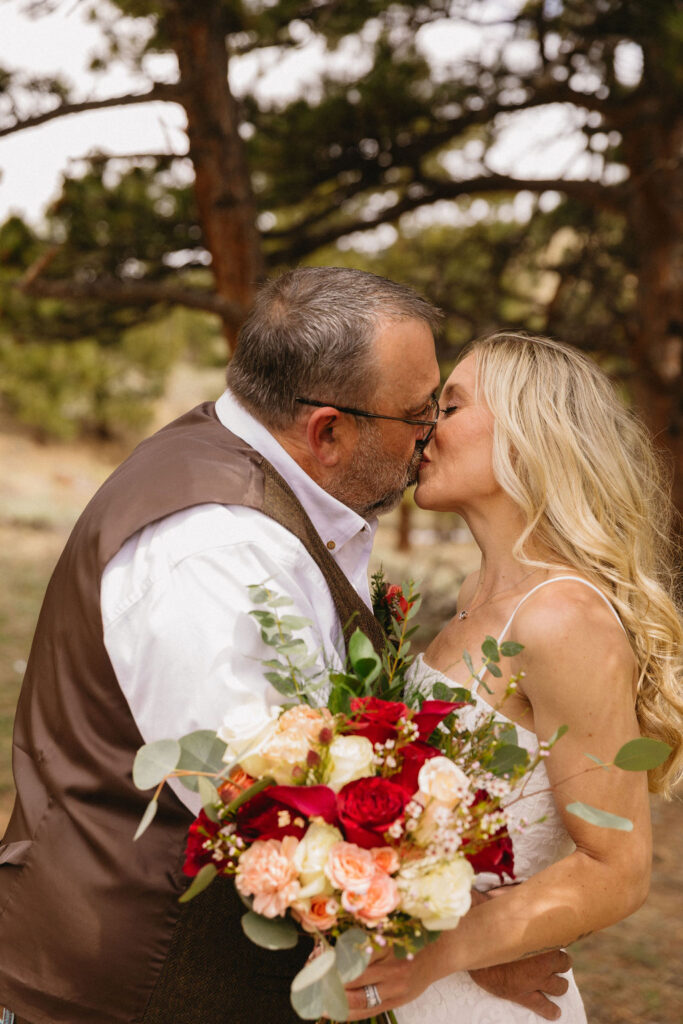 gorgeous rocky mountain elopement image of bride and groom kissing