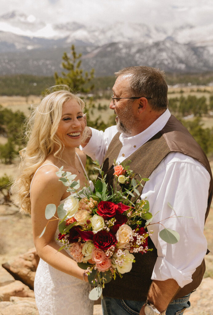 Estes Park wedding photos with red and white bouquet