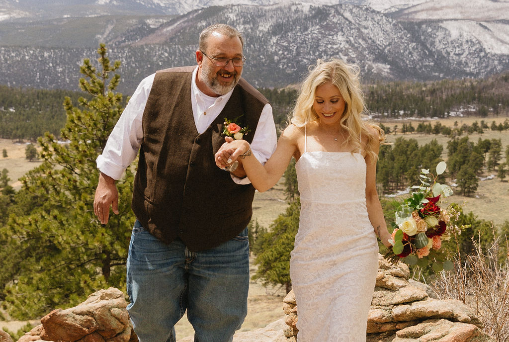 Estes Park wedding photos with red and white bouquet