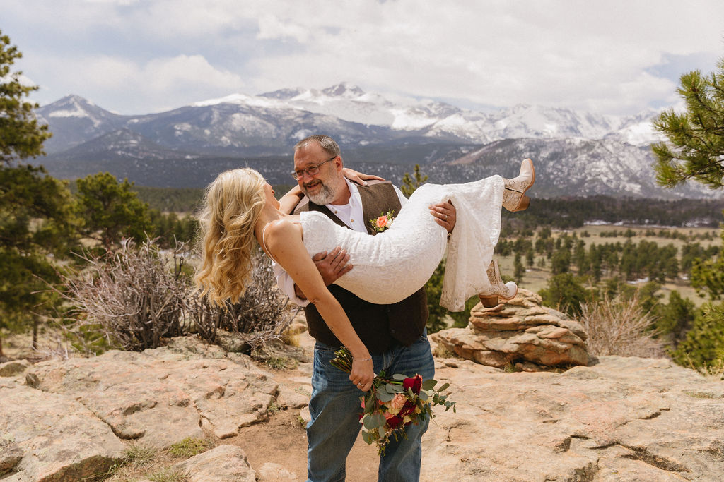 Gorgeous wedding photo of a groom carrying his bride at 3M Curve