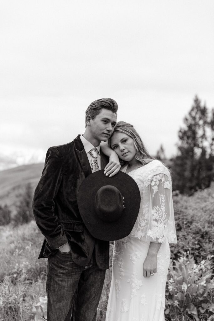 Black and white portrait of bride and groom posing in western wedding attire at their Jackson Hole elopement