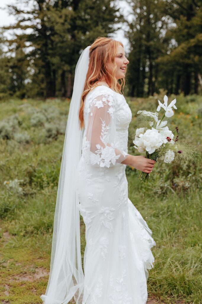 Bride holding her bouquet walking to her wedding ceremony at The Wedding Tree in Jackson, WY