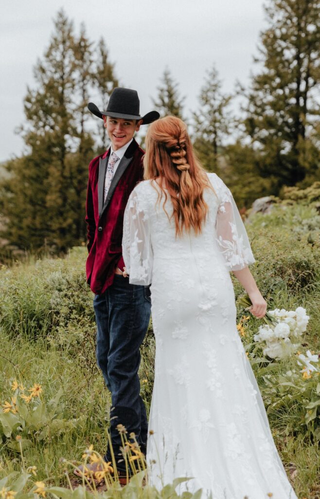 Groom seeing his bride for the first time during their Jackson Hole elopement in a meadow