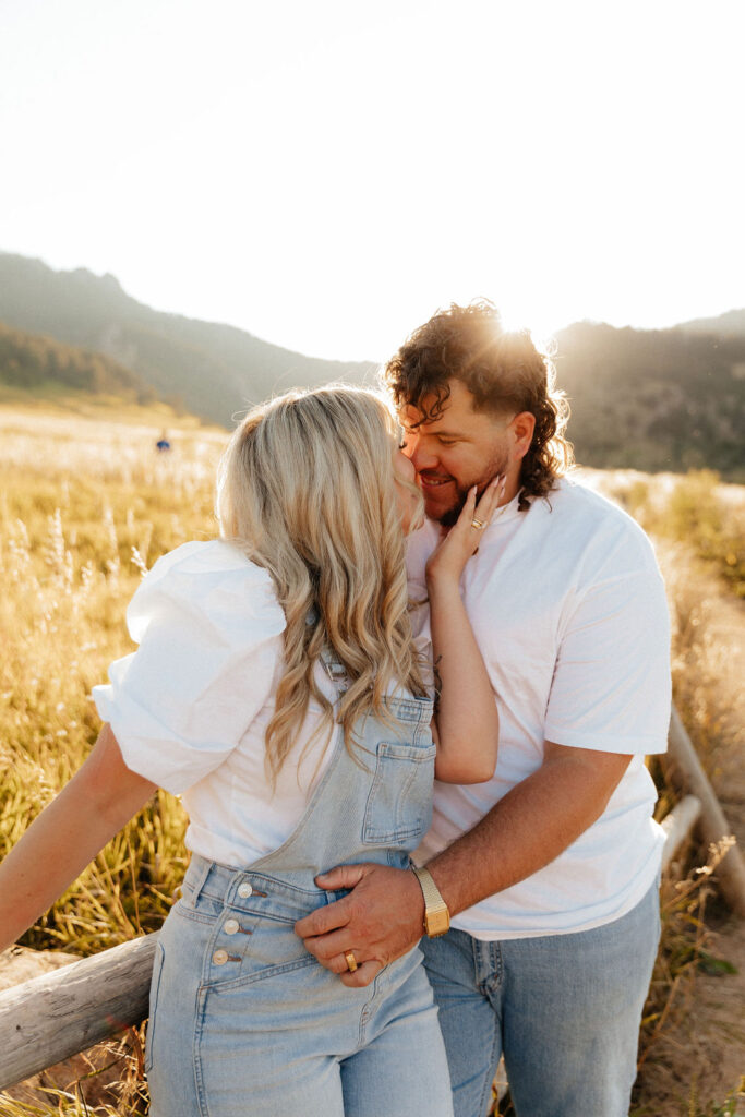 cute rustic engagement photos of a couple in white T shirts and jeans