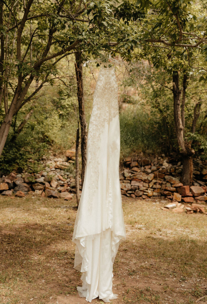 Wedding dress hanging from a tree at Stone Mountain Lodge