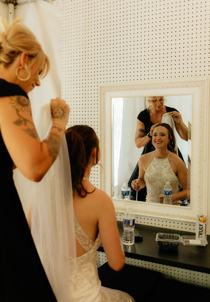 Bride putting her veil in in the bridal tent 