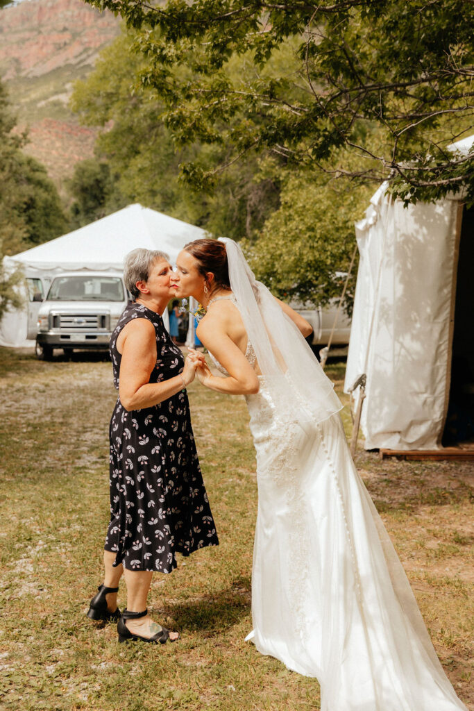 mom preparing to send her daughter down the aisle