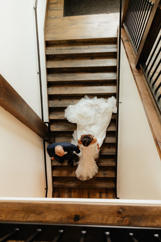 bride and groom walking down the stairs 