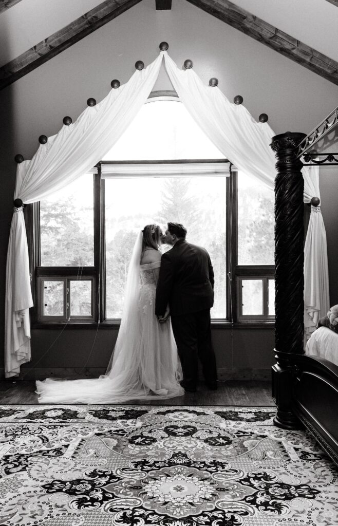 cottage wedding photo of bride and groom by window