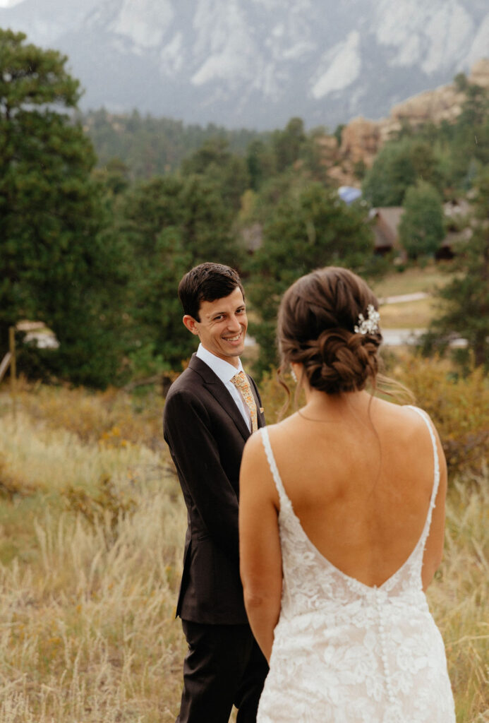 outdoor bride and groom first look in the mountains