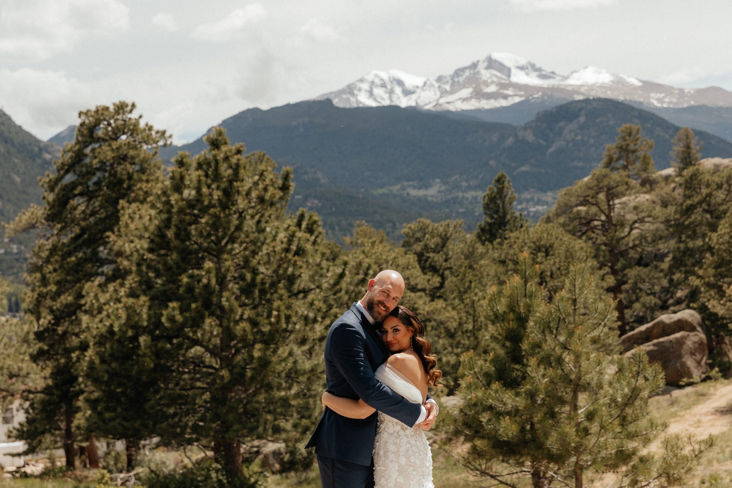 classic wedding portrait of bride and groom in front of mountains