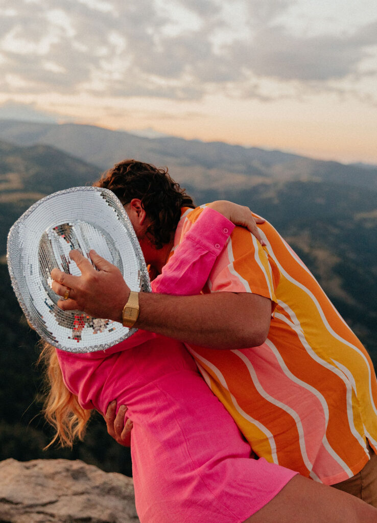 retro vibe lost gulch overlook engagement photos with fun outfits, disco ball and a disco cowboy hat