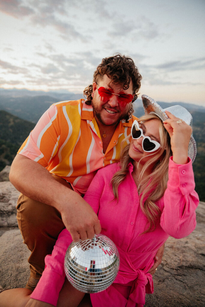 retro vibe lost gulch overlook engagement photos with fun outfits, disco ball and a disco cowboy hat