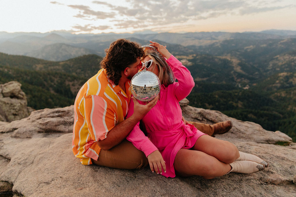 retro vibe lost gulch overlook engagement photos with fun outfits, disco ball and a disco cowboy hat