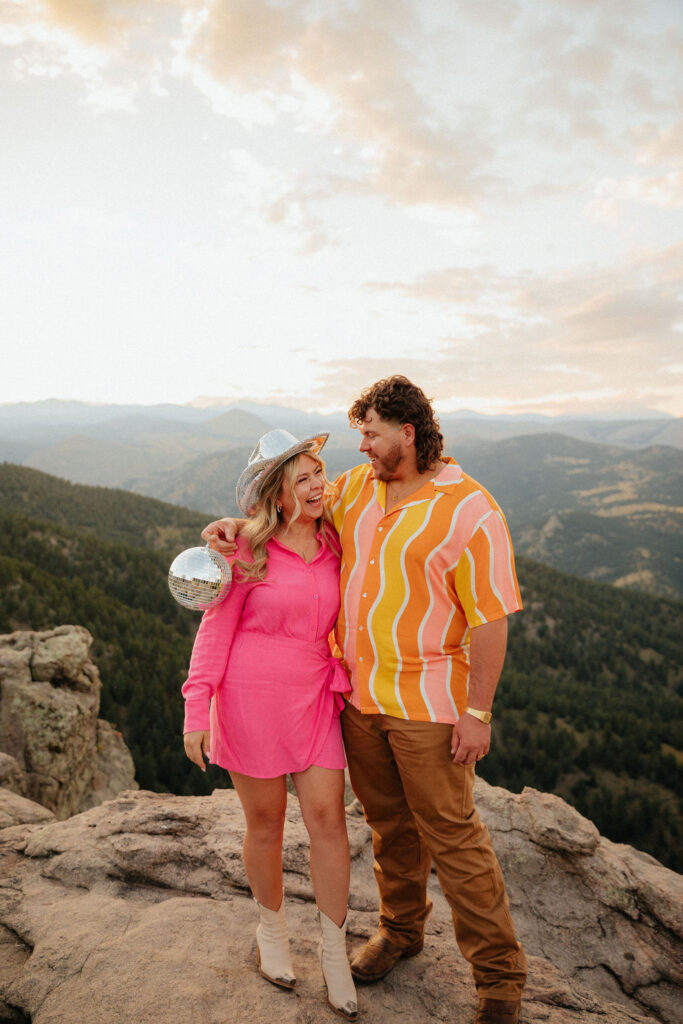 retro vibe lost gulch overlook engagement photos with fun outfits, disco ball and a disco cowboy hat