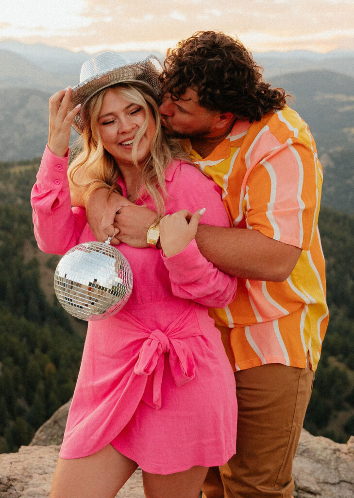 retro vibe lost gulch overlook engagement photos with fun outfits, disco ball and a disco cowboy hat