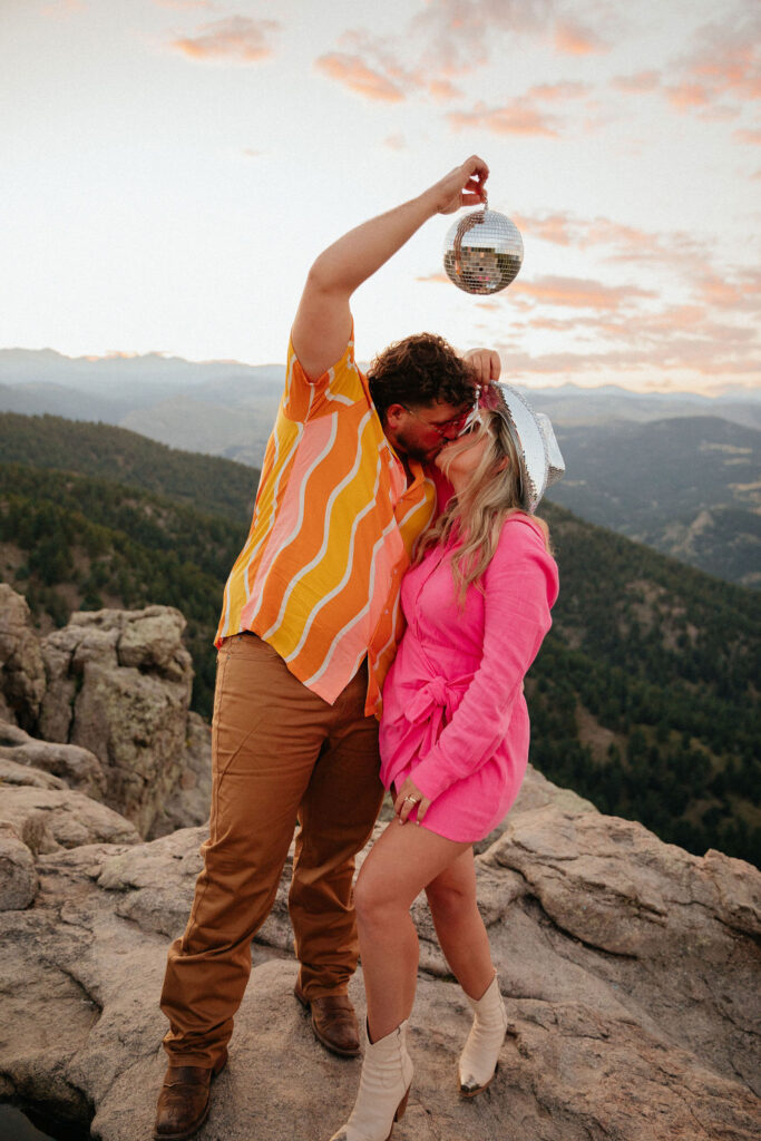 retro vibe lost gulch overlook engagement photos with fun outfits, disco ball and a disco cowboy hat