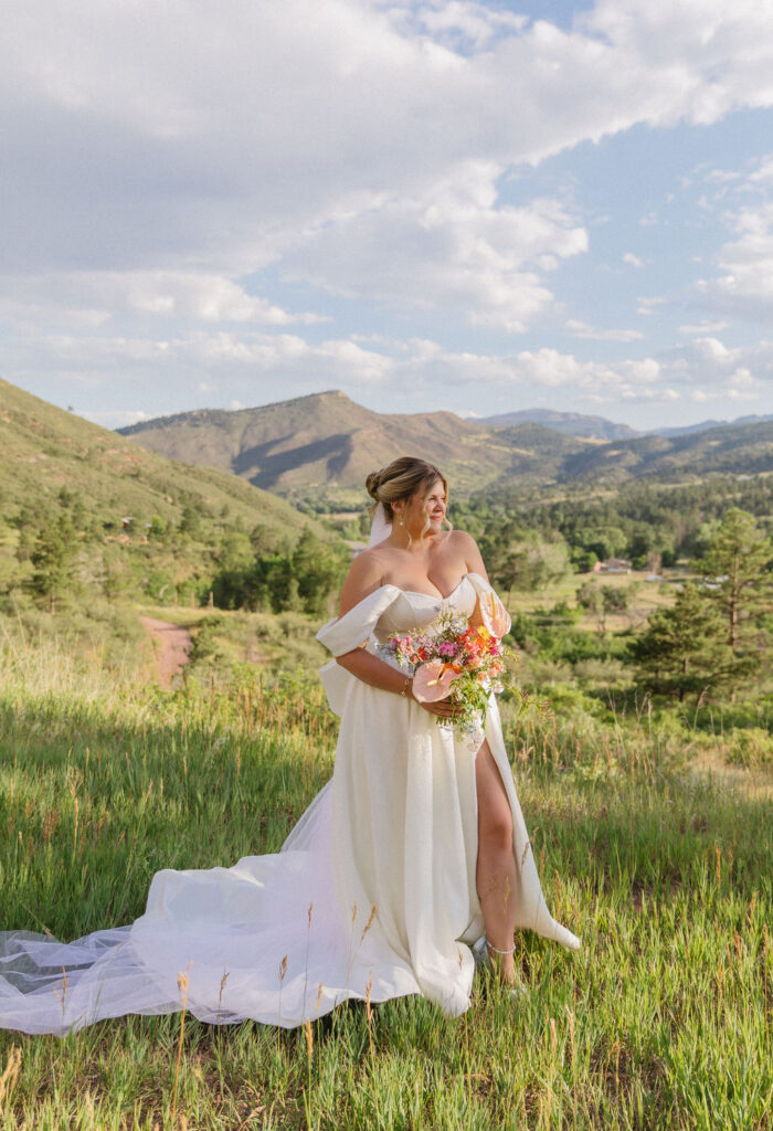 Rocky mountain bride with colorful wedding bouquet at Stone mountain lodge summer wedding