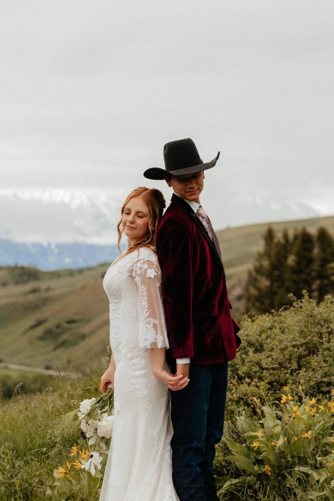 romantic and intimate bride and groom standing in a lush wildflower field