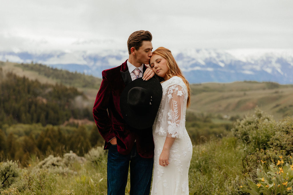 romantic and intimate bride and groom standing in a lush wildflower field